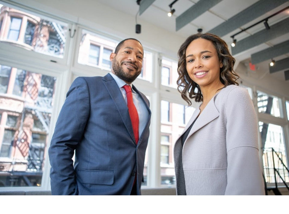 2 professionals standing in an office
