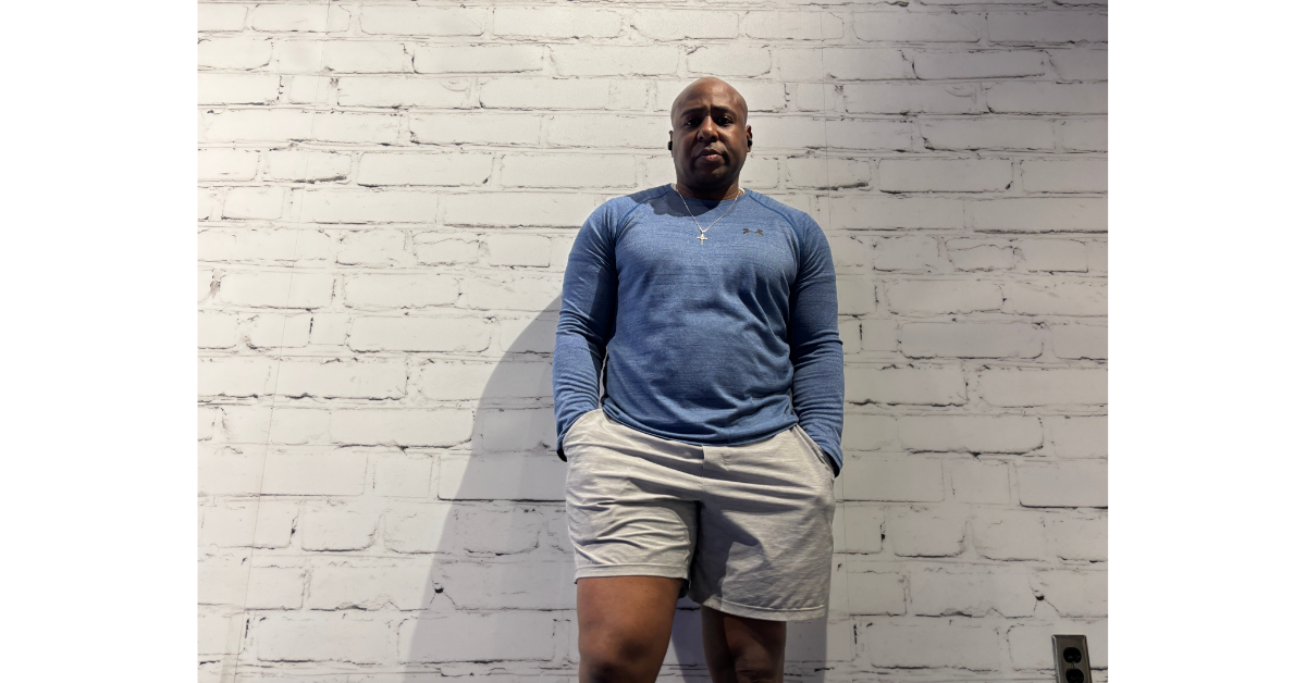 Eric leaning against a wall after a workout